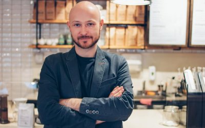 portrait-of-attractive-adult-successful-bald-bearded-man-in-suit-on-cafe-coffee-house-background_t20_8dp9xj